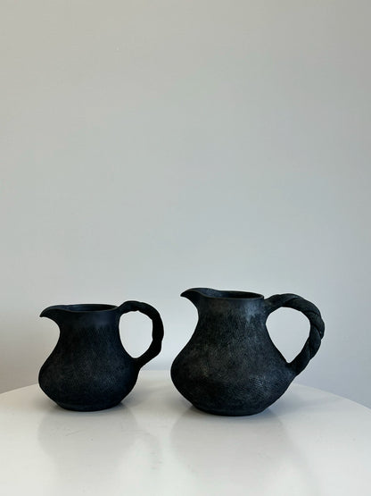 How many handmade coffee sharing pots and milk teapots in the black pottery area