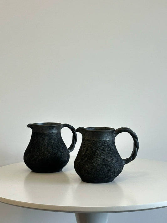 How many handmade coffee sharing pots and milk teapots in the black pottery area