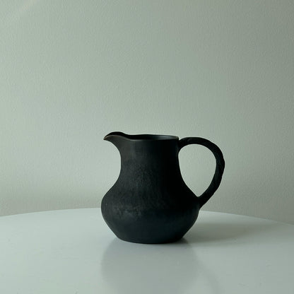 How many handmade coffee sharing pots and milk teapots in the black pottery area